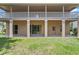 Spacious patio with direct yard access, complemented by sliding glass doors and a neutral color palette at 1097 Harmony Ln, Clermont, FL 34711