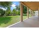 View of the backyard from the covered back porch and the lush landscaping adds privacy at 1097 Harmony Ln, Clermont, FL 34711