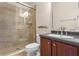 Bathroom featuring a glass-enclosed shower and a vanity with a dark countertop at 1097 Harmony Ln, Clermont, FL 34711