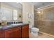 Well-maintained bathroom featuring a glass shower, vanity with solid countertops, and tile floors at 1097 Harmony Ln, Clermont, FL 34711