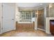 Bathroom with a large soaking tub, tiled surround, and a separate glass-enclosed shower at 1097 Harmony Ln, Clermont, FL 34711