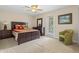 Comfortable bedroom with ceiling fan, carpet floors, and a door with view to outside at 1097 Harmony Ln, Clermont, FL 34711