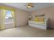 Bright bedroom with a daybed, large window, and neutral carpet, creating a serene space at 1097 Harmony Ln, Clermont, FL 34711