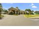 Exterior of the clubhouse featuring a covered entrance and well-manicured landscaping at 1097 Harmony Ln, Clermont, FL 34711