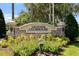 The Legends Clubhouse sign with lush landscaping at 1097 Harmony Ln, Clermont, FL 34711