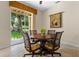 Dining room features a round wood table and a sliding glass door leading to the backyard at 1097 Harmony Ln, Clermont, FL 34711