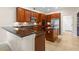 Spacious kitchen features wood cabinets, granite countertops and stainless steel appliances at 1097 Harmony Ln, Clermont, FL 34711