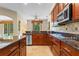 Spacious kitchen features wood cabinets, granite countertops and stainless steel appliances at 1097 Harmony Ln, Clermont, FL 34711