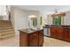 Bright eat-in kitchen features an island with granite counters, stainless appliances, and tile flooring at 1097 Harmony Ln, Clermont, FL 34711
