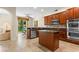 Spacious kitchen features wood cabinets, stainless steel appliances and a view of the backyard at 1097 Harmony Ln, Clermont, FL 34711