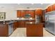 Spacious kitchen features wood cabinets, granite countertops and stainless steel appliances at 1097 Harmony Ln, Clermont, FL 34711
