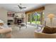 Bright living room features a fireplace, neutral carpeting and large sliding glass doors leading to the backyard at 1097 Harmony Ln, Clermont, FL 34711