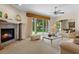 Bright living room features a fireplace, neutral carpeting and large sliding glass doors leading to the backyard at 1097 Harmony Ln, Clermont, FL 34711