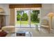 Bright living room features large sliding glass doors with view of the backyard at 1097 Harmony Ln, Clermont, FL 34711