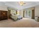 Expansive main bedroom with tray ceilings, french doors to the patio, and walk-in closet at 1097 Harmony Ln, Clermont, FL 34711