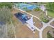 Aerial view of community playground and tennis courts, surrounded by lush landscaping and sidewalks at 1097 Harmony Ln, Clermont, FL 34711