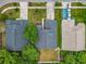Aerial view showing roof, backyard, trees, driveway, and relationship to neighboring houses and street at 1131 Tyler Lake Cir, Orlando, FL 32839