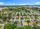 Scenic aerial view captures the neighborhood, nearby lake, and cityscape beyond the lush trees at 1131 Tyler Lake Cir, Orlando, FL 32839