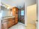 Bathroom featuring custom wood vanity, granite countertop, and glass-enclosed shower at 1131 Tyler Lake Cir, Orlando, FL 32839