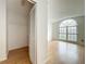 Bright bedroom featuring a large window, hardwood floors, and a walk-in closet offers ample space and natural light at 1131 Tyler Lake Cir, Orlando, FL 32839