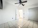 Bedroom with tile flooring and open door view to a bright room at 1131 Tyler Lake Cir, Orlando, FL 32839