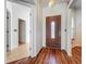 Entryway featuring wood floors, a decorative front door, and an open view into other rooms at 1131 Tyler Lake Cir, Orlando, FL 32839