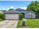 Lovely single-story home featuring a two-car garage, well-kept lawn, and pathway to the front door at 1131 Tyler Lake Cir, Orlando, FL 32839