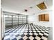 Spacious garage with black and white checkered flooring and overhead door and storage at 1131 Tyler Lake Cir, Orlando, FL 32839
