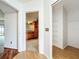 Bright hallway features hardwood floors, a view into the kitchen, and a coat closet with shelving at 1131 Tyler Lake Cir, Orlando, FL 32839