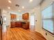 Spacious kitchen with wood floors, granite counters and stainless steel dishwasher under wood cabinets at 1131 Tyler Lake Cir, Orlando, FL 32839