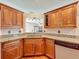 Corner view of the kitchen featuring wood cabinets and granite counters at 1131 Tyler Lake Cir, Orlando, FL 32839