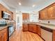 Kitchen with granite counters, stainless appliances and wood cabinets and flooring at 1131 Tyler Lake Cir, Orlando, FL 32839