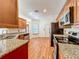 Updated kitchen features stainless appliances, granite countertops and wood flooring at 1131 Tyler Lake Cir, Orlando, FL 32839