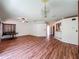 Large open living room with decorative light fixture, and pass through to kitchen at 1131 Tyler Lake Cir, Orlando, FL 32839