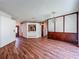 Expansive living room featuring wood floors, decorative light fixture, and pass through to kitchen at 1131 Tyler Lake Cir, Orlando, FL 32839