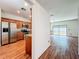 Open floor plan featuring a kitchen with stainless steel appliances and a living room with glass doors at 1131 Tyler Lake Cir, Orlando, FL 32839