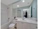 Full bathroom featuring a large mirror, shower and tub, and tile flooring at 11854 Delfina Ln, Orlando, FL 32827