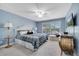 Bright bedroom featuring blue walls, carpet floors, and a window with shutters at 11854 Delfina Ln, Orlando, FL 32827