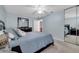 Well-lit bedroom featuring blue walls, a ceiling fan, a closet, and a large mirror at 11854 Delfina Ln, Orlando, FL 32827
