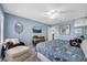 Comfortable bedroom with blue walls, ceiling fan, and decorative accents at 11854 Delfina Ln, Orlando, FL 32827