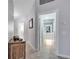 Bright hallway featuring neutral paint, tile flooring, and an entryway to a bathroom at 11854 Delfina Ln, Orlando, FL 32827