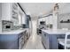 Open concept kitchen features modern stainless steel appliances, island and adjacent living area at 11854 Delfina Ln, Orlando, FL 32827