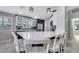 The kitchen with bar seating, white countertops and modern light fixtures at 11854 Delfina Ln, Orlando, FL 32827