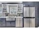 Updated kitchen featuring stainless steel appliances, farmhouse sink and mosaic backsplash at 11854 Delfina Ln, Orlando, FL 32827