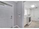 Bright laundry room with white cabinets, white washer/dryer and glass block window at 11854 Delfina Ln, Orlando, FL 32827