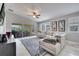 Bright living room features tile floors, ceiling fan, and sliding glass doors to an outdoor patio at 11854 Delfina Ln, Orlando, FL 32827