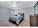 Well-lit bedroom showcasing a ceiling fan, window with shutters, and wood furniture at 11854 Delfina Ln, Orlando, FL 32827