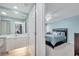 Stylish bedroom with a ceiling fan, and a private bathroom featuring a tile floor and shower at 11854 Delfina Ln, Orlando, FL 32827