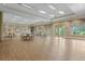 The large meeting room features wood-look floors, neutral walls, and large windows; ideal for community gatherings at 11854 Delfina Ln, Orlando, FL 32827