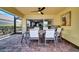 Covered patio featuring brick pavers, a ceiling fan, and dining set adjacent to sliding doors to indoor space at 11854 Delfina Ln, Orlando, FL 32827
